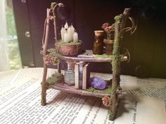 an old fashioned shelf with candles and other items on it sitting on top of a book