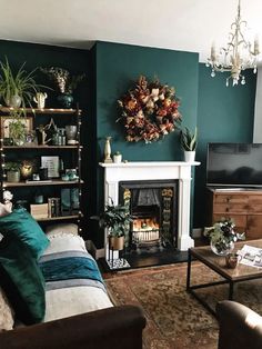 a living room filled with furniture and a fire place in front of a tv mounted on a wall