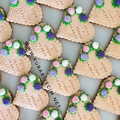 many decorated cookies are arranged in the shape of heart shaped hearts with flowers on them