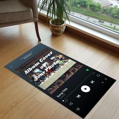 an image of a music player on the floor in front of a window with a potted plant