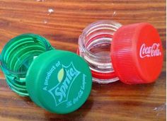 three plastic containers sitting on top of a wooden table next to each other with the lids closed