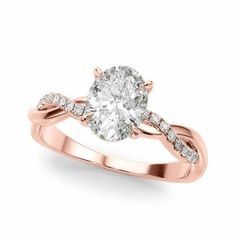 a rose gold engagement ring with an oval cut diamond in the center