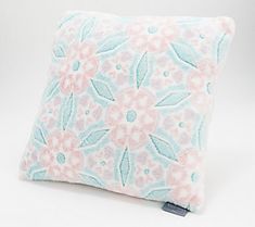 a pink and blue pillow with flowers on it