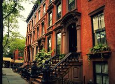 an apartment building with many windows and balconies on the side walk next to it