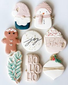 decorated cookies are arranged on a white surface