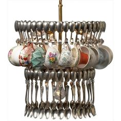 a chandelier with spoons and cups hanging from it's sides on a white background