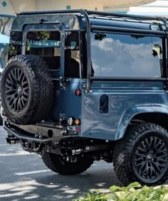 a blue jeep is parked on the street