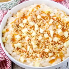 a bowl filled with oatmeal topped with apples