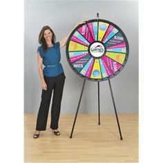 a woman standing next to a spinning wheel