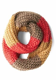 a multicolored knitted scarf on a white background