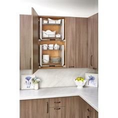 a kitchen with wooden cabinets and white counter tops