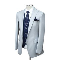 Package Includes: 1 x Jacket - 1 x Waistcoat - 1 x Pant

Introducing our Custom Grey Suit with Blue Vest, a masterpiece of timeless elegance and modern sophistication. Impeccably tailored from luxurious 120s fabric and lined with sumptuous silk, this suit exudes confidence and style. Featuring brass buttons, a half-canvas construction, and a striking blue vest with grey piping, it's the epitome of sartorial excellence. Elevate your wardrobe with this statement piece today.

 	Fabric: 120s
 	Lini Luxury Fitted Single Breasted Three-piece Suit, Luxury Fitted Single-breasted Three-piece Suit, Elegant Three-piece Suit With Custom Fit And Suit Collar, Elegant Tailored Suits With Lapel Collar, Elegant Custom Fit Three-piece Suit For Office, Elegant Single Breasted Suit In Suiting Fabric, Elegant Single Breasted Suit, Elegant Single-breasted Three-piece Suit, Elegant Single-breasted Suit