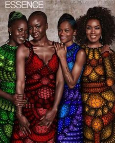 three women in colorful dresses standing next to each other with their arms around one another