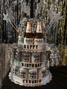 a cake made to look like two bottles of beer on top of each other with the words happy birthday written on them