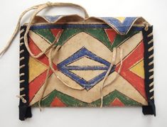 an old handbag is decorated with multicolored designs