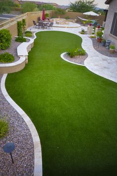 a backyard with artificial grass and landscaping