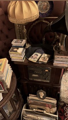 an old radio sitting on top of a wooden table next to a lamp and chair