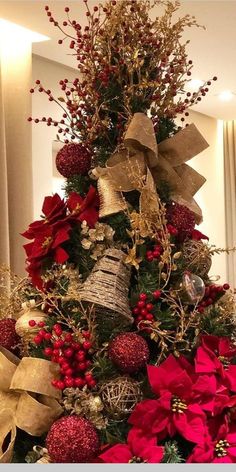 a decorated christmas tree with bells and poinsettis