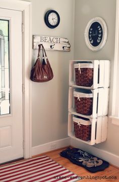 a white door with some baskets on it and a bag hanging from the wall next to it