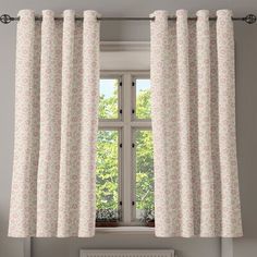 a window with curtains hanging on the side of it and a radiator next to it