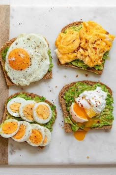 toast with eggs and avocado on it sitting on top of a cutting board