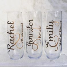 three wine glasses with gold lettering on them