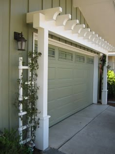 an image of two garage doors with vines growing on the side of them and below