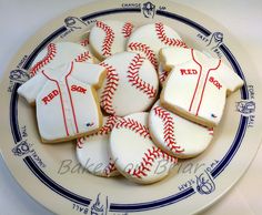 cookies decorated with baseball uniforms and shirts on a plate