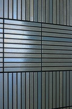 a close up view of a metal wall with vertical lines on the side and bottom