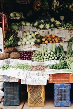 an outdoor fruit and vegetable stand with lots of fresh fruits and vegetables on display for sale