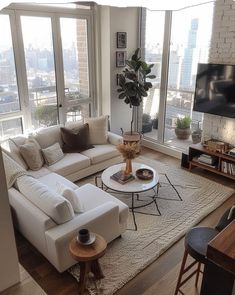 a living room filled with furniture and a flat screen tv mounted to the wall next to a window