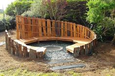 a wooden bench sitting in the middle of a garden