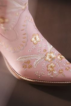 Botanical embroidery dances across these playful Western-inspired boots, finished with a low heel and an almond toe for effortless comfort. | Primrose Leather Booties by Dingo 1969 in Pink, Women's, Size: 6.5 at Anthropologie Bride Boots, Cowboy Embroidery, Cute Cowgirl Boots, Pink Cowboy Boots, Pink Cowgirl Boots, Botanical Embroidery, Wedding Boots, Cheap Boots, Pink Boots