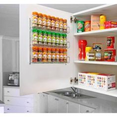 an organized pantry with lots of food in the cupboards and on the wall is a sink