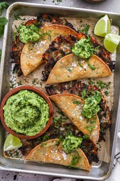 tortillas with guacamole and salsa on a baking sheet