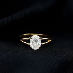 a gold ring with a white diamond on it