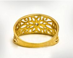 a gold ring with an intricate design on it