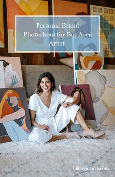 a woman sitting on the floor in front of some paintings with text that reads personal brand photoshoot for bay area artist