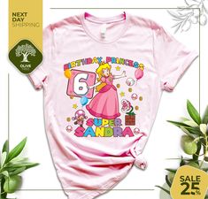 a pink tshirt with an image of princess peach on it and the words g is