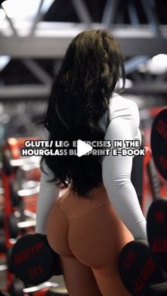 the back of a woman's body with dumbbells in front of her