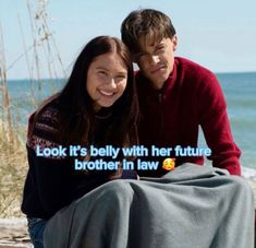 a man and woman sitting next to each other on a bench near the ocean with text that reads, look it's belly with her future brother in law