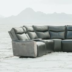 a couch that is sitting in the sand