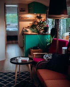 a living room filled with furniture and a lamp