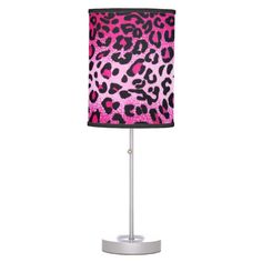 a pink and black leopard print lamp on a white base with a black fabric shade