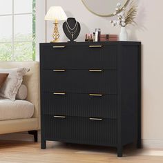 a black chest of drawers in a living room