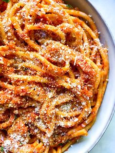 pasta with parmesan cheese and tomato sauce in a bowl