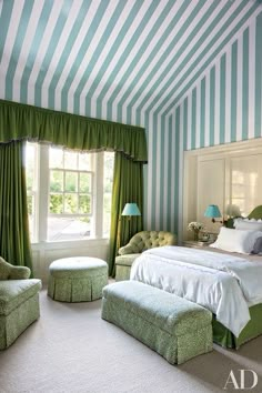 a bedroom with green and white striped walls