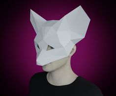 a man with a paper mask on his face is looking at the camera while standing in front of a purple background