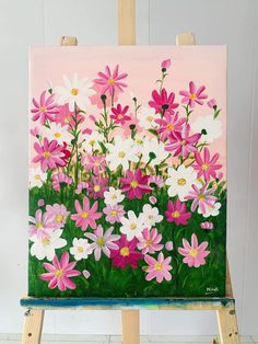 an easel with a painting of pink and white flowers on it