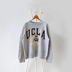 90s University of California UCLA sweatshirt/ M * PLEASE READ BEFORE PURCHASE * PLEASE consider the PHOTOS before making the decision * The images may DIFFER in appearance from the actual product because we took pictures under daylight.  * PLEASE send your PHONE NUMBER after your purchase for the shipping company to contact you X No returns X No refund Condition : 8/10 More details : hole (back)/ look at the pictures  Brand : Galt sand Size : M Pit to pit/ Chests : 22.5/45 inches  Length : 26 inches  Material : cotton polyester  Color : gray * ALL ITEMS are VINTAGE which may show some signs of wear and tear * Due to the different display and different light, the picture may not reflect the actual color of the item * Please, remember that our items are vintage so they may show some signs of Ucla Sweatshirt, Ucla University, Ucla Bruins, Shipping Company, University Of California, Phone Number, Sweat Shirt, Gender Neutral, Art Collection